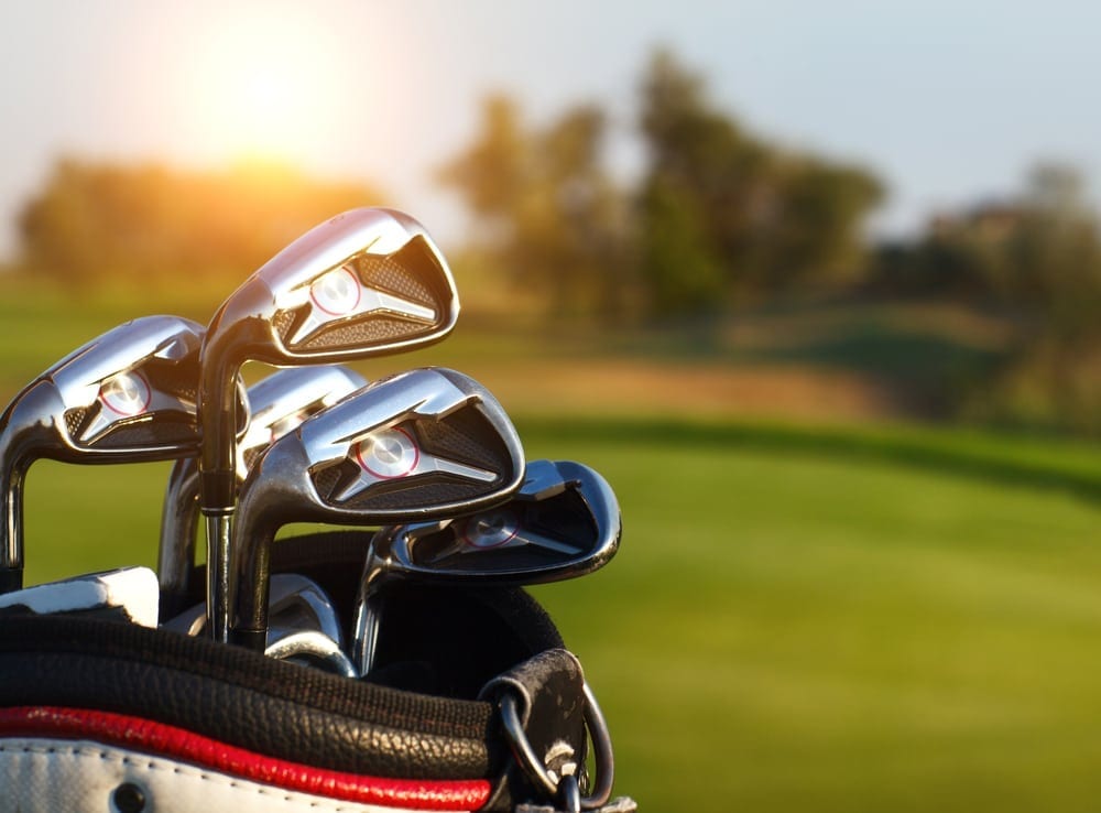 close up of golf clubs in a bag