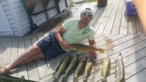 A proud young man displays his bountiful haul of walleye at Hall's Cottages.